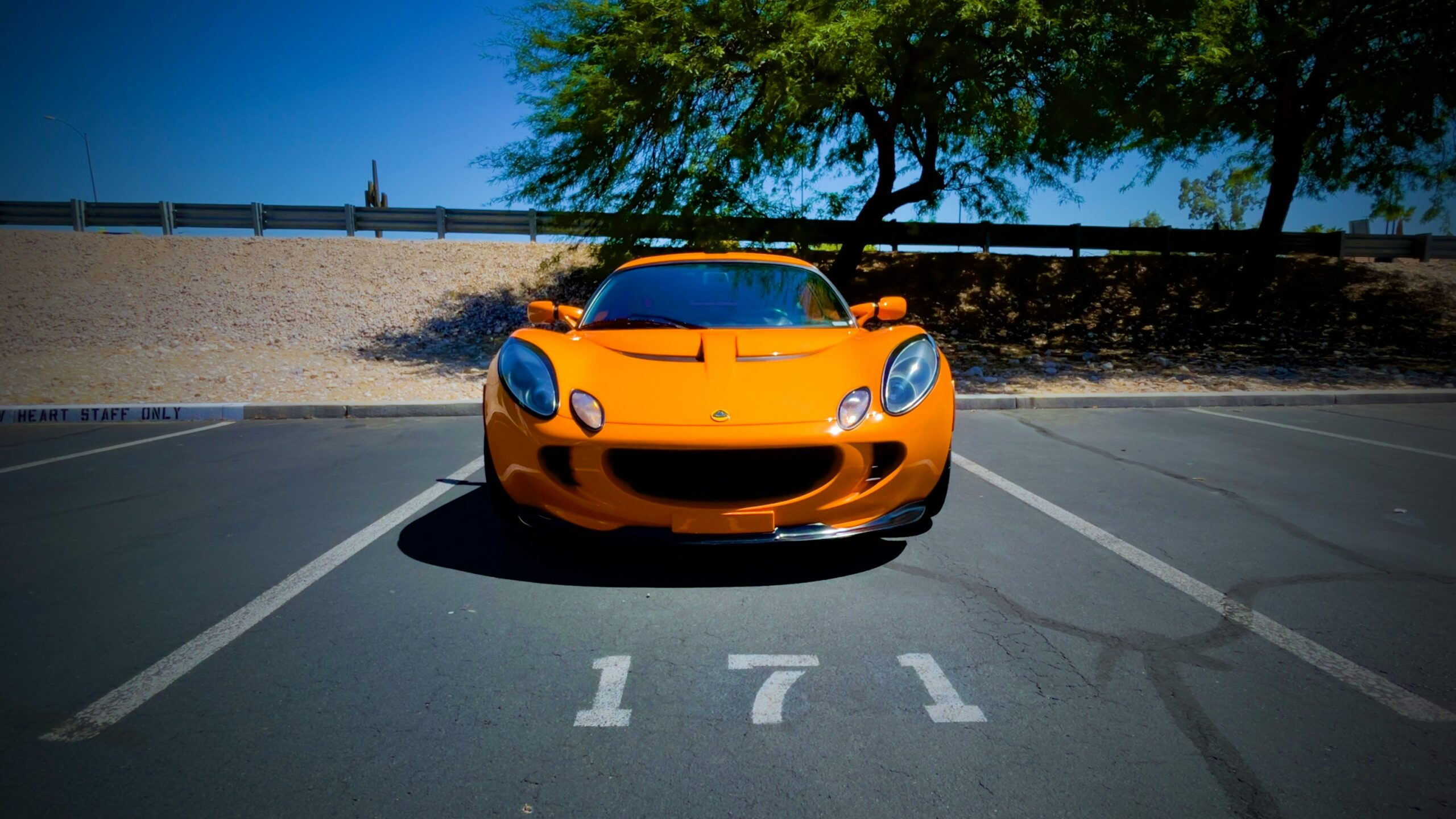 a yellow sports car parked in a parking lot